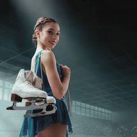 Young female figure skater dressed in a teal figure skating dress carries her white figure skates over shoulder. She is smiling at the camera. 